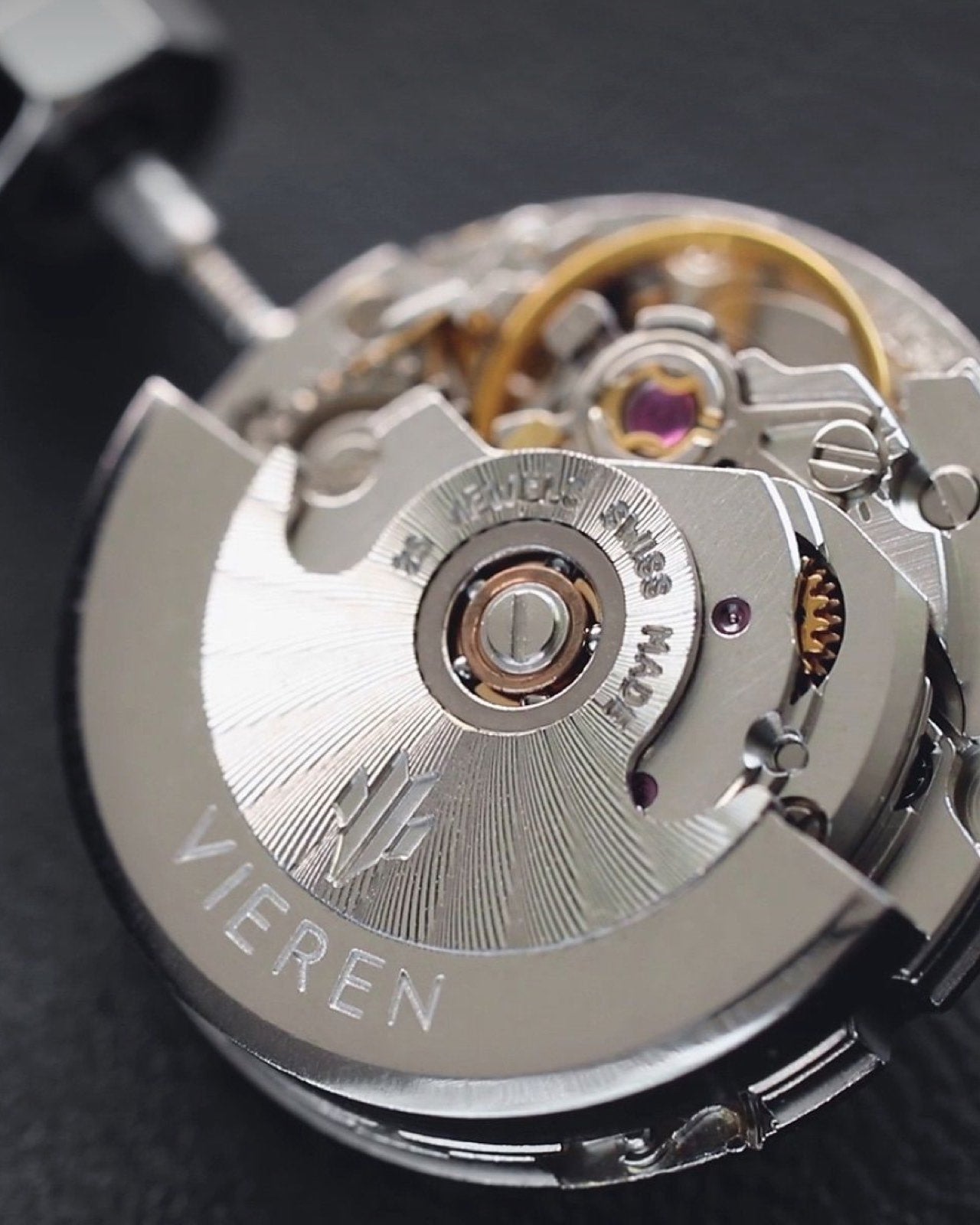 Closeup of Swiss Made ETA 2671 automatic movement with rotor, balance wheel, and jewels