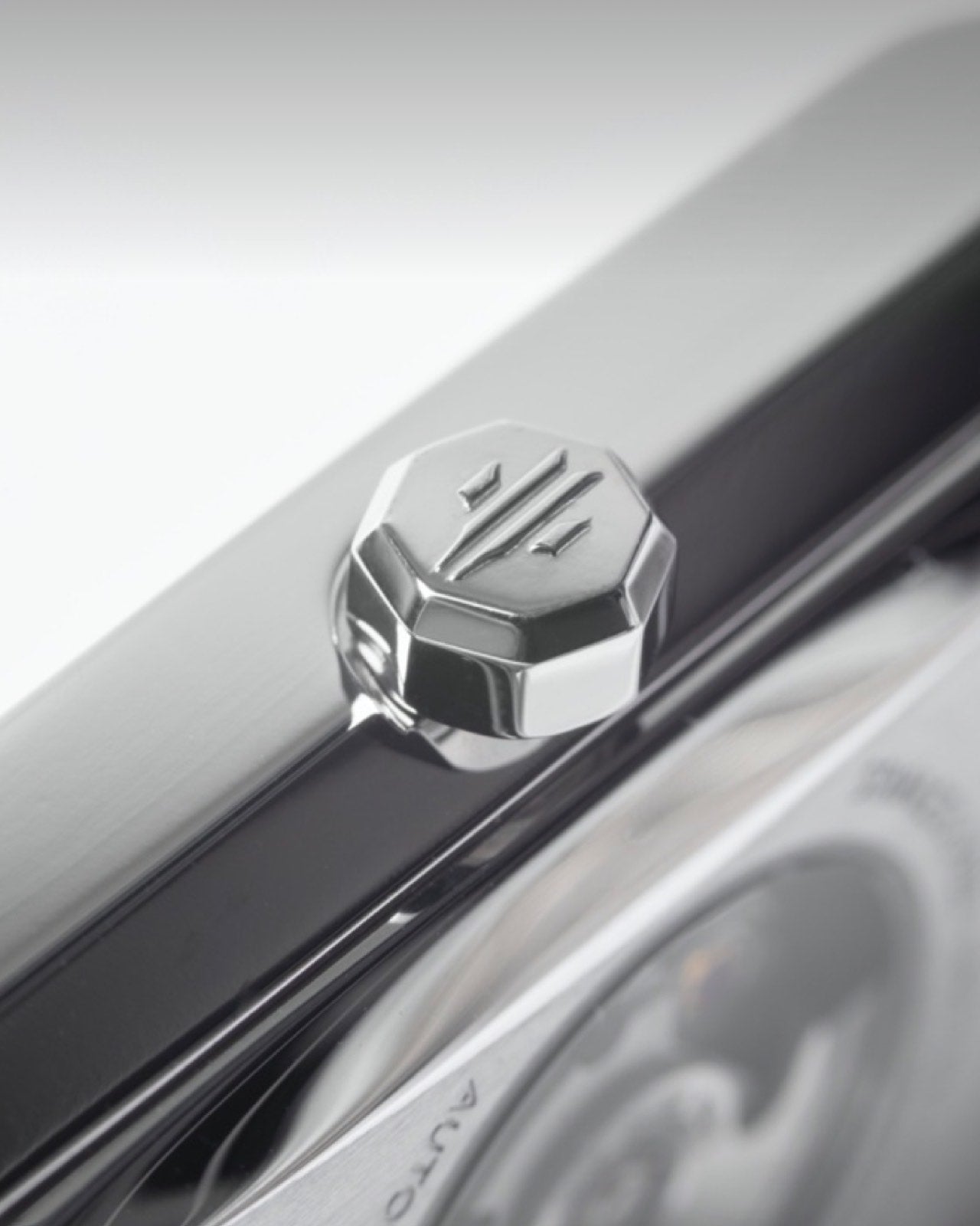 Close-up of octagonal crown on rectangular automatic watch case profile