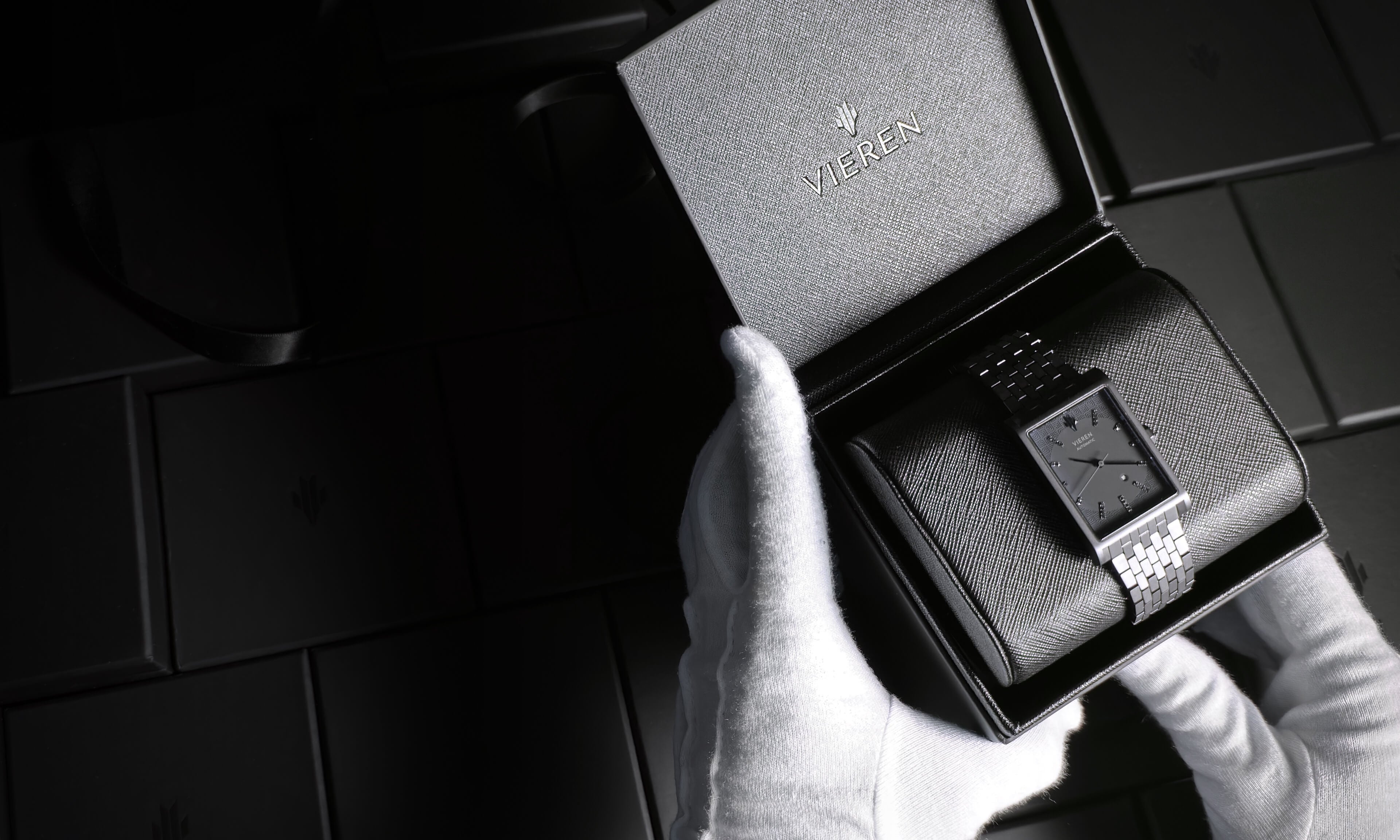 VIEREN black rectangular watch with gift box packaging held by white gloves