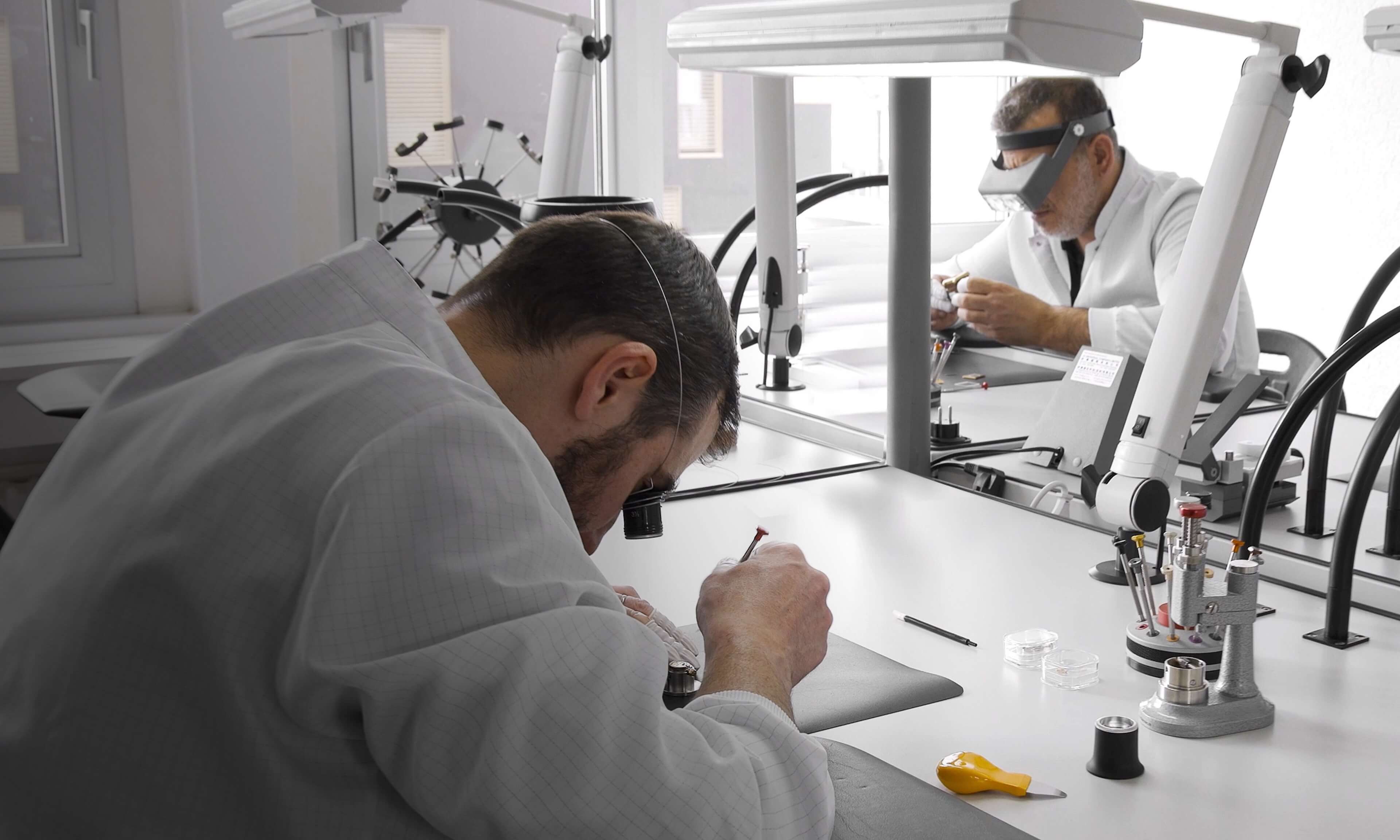 Swiss watchmakers crafting VIEREN rectangular watches with tools in the horology studio