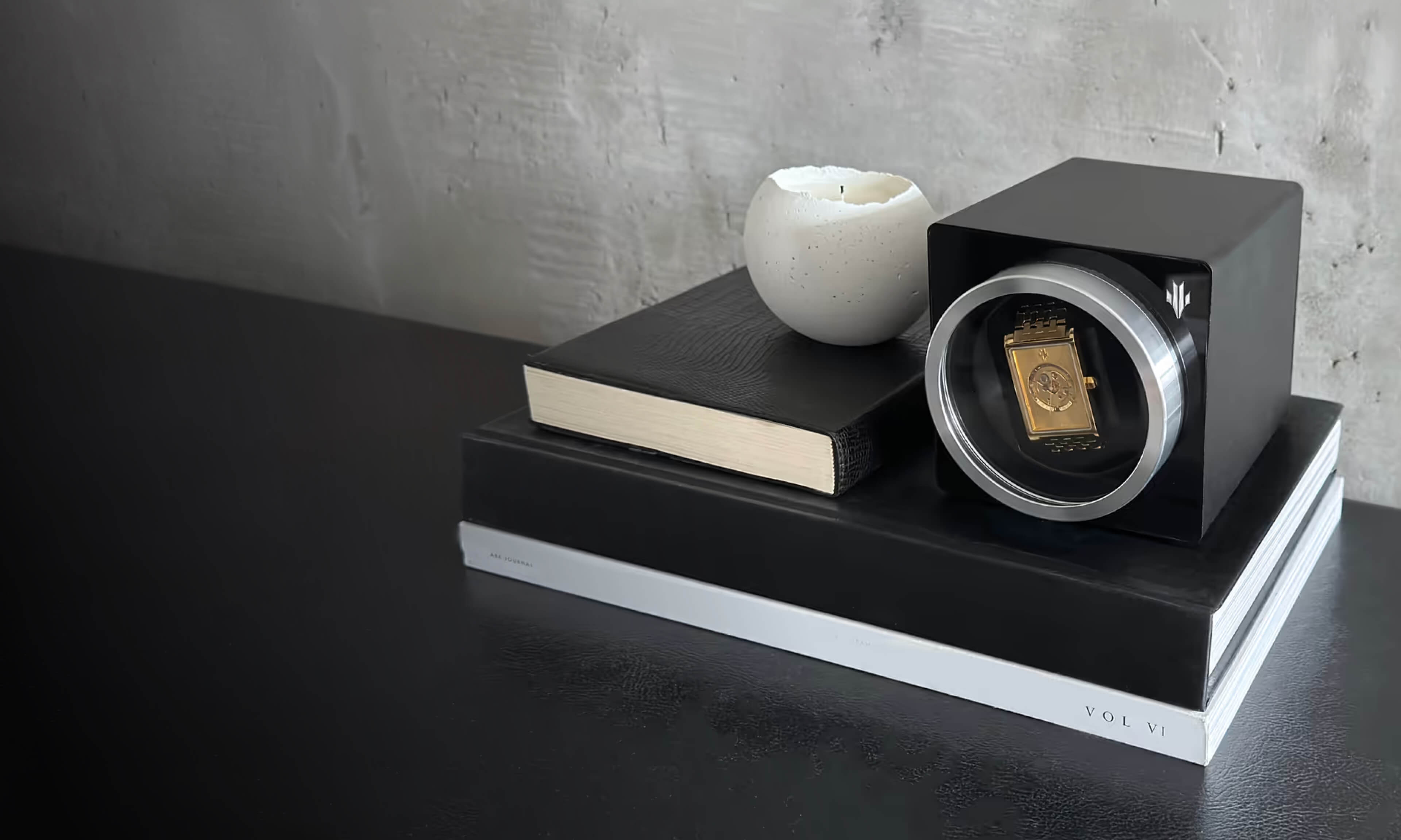 VIEREN Gold rectangular watch displayed in an automatic watch winder with books in a lifestyle setting
