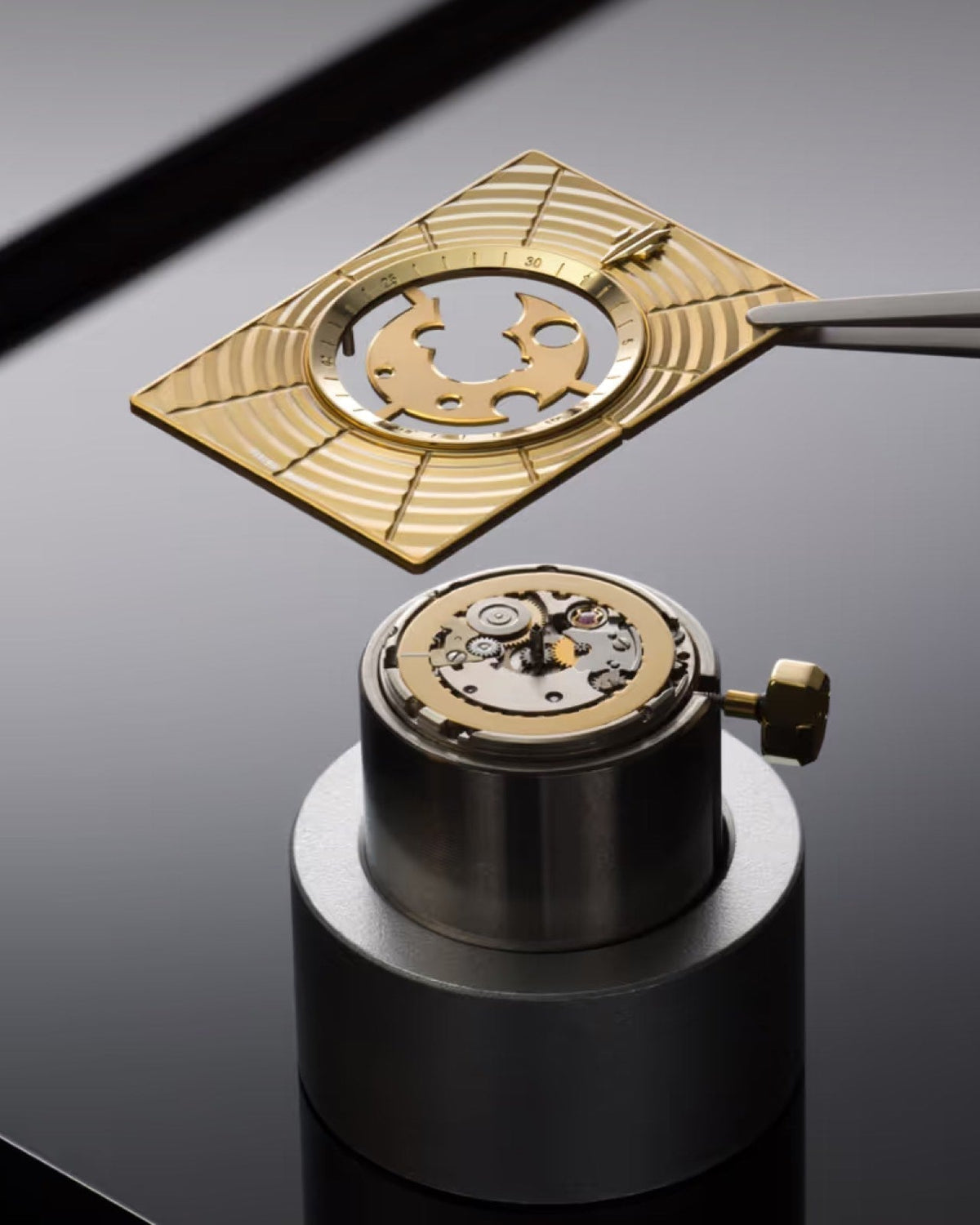 Luxury gold rectangular skeleton dial being placed on Swiss Made automatic watch movement with gold date disc