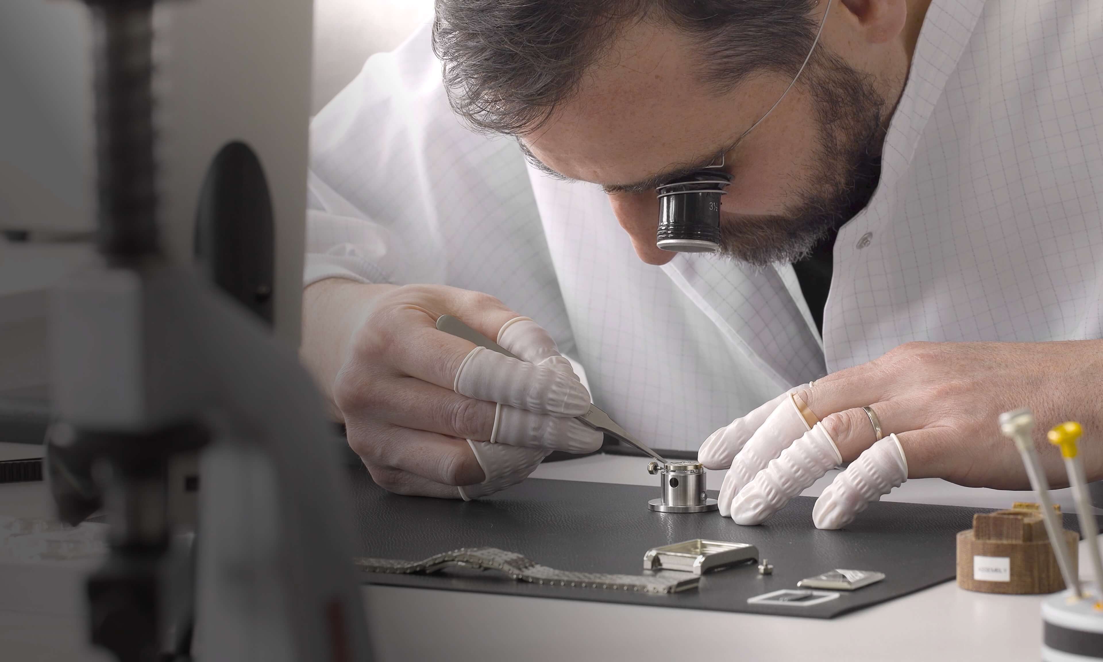 Swiss watchmaker crafting VIEREN Swiss Made automatic rectangular watches with loupe
