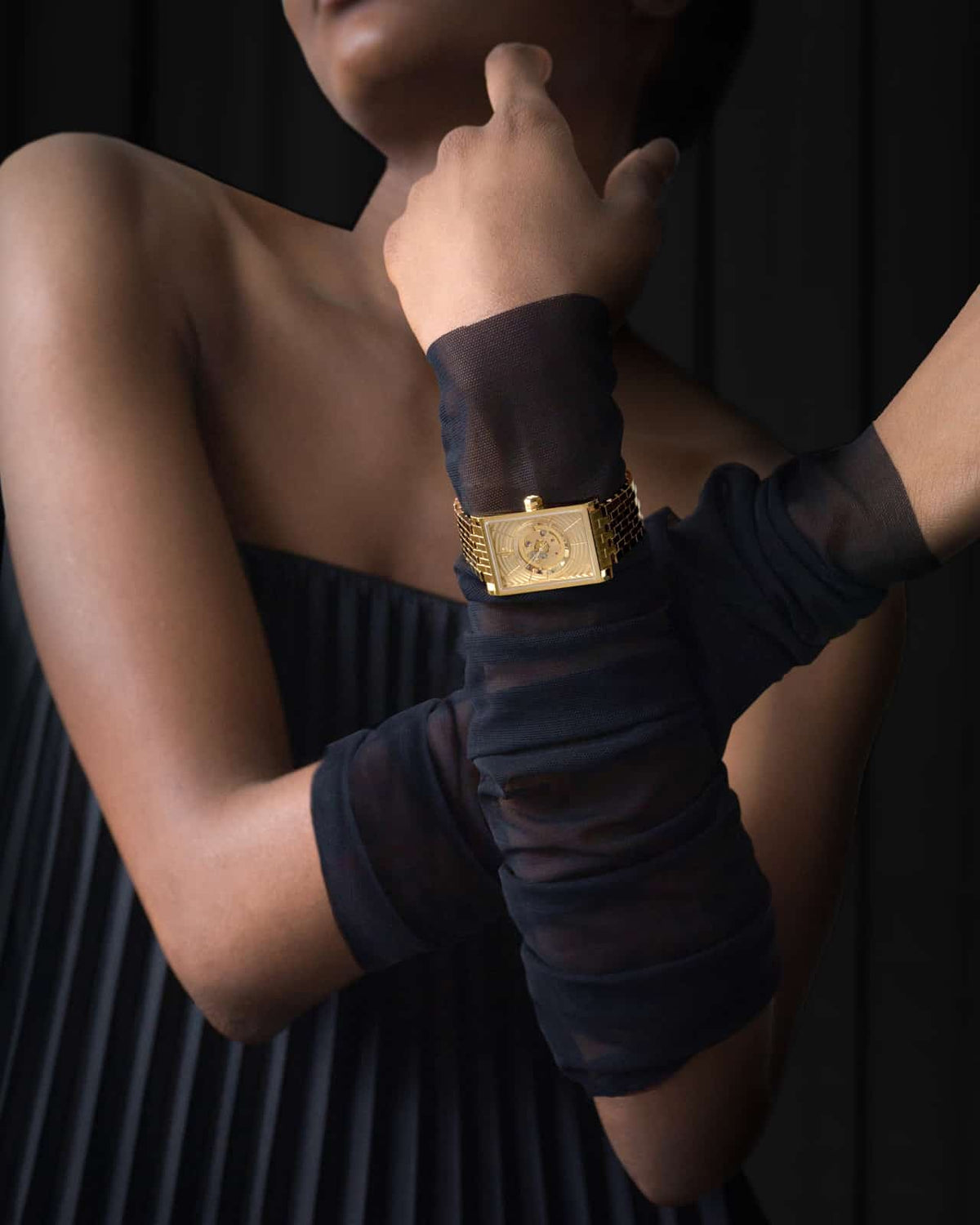 VIEREN women's gold rectangular watch styled with a black dress